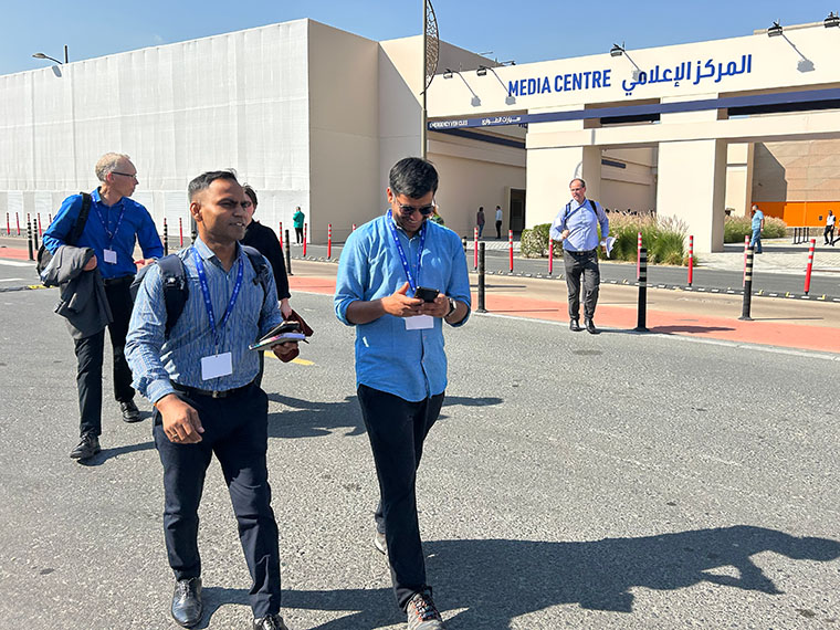 Reporters Gaurav Saini (left) and Sibi Arasu walk to an assignment during COP28 in Dubai. (Photo by Devon Terrill)